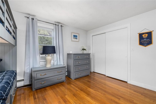 57 Hillside Rd, Lincoln, RI 02865 - bedroom with wood finished floors, a closet, and a baseboard radiator