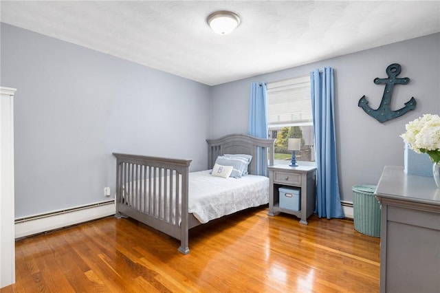 57 Hillside Rd, Lincoln, RI 02865 - bedroom with baseboard heating, light wood finished floors, and a baseboard radiator