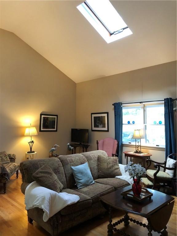 2 Marywood Ln, Cumberland, RI 02864 - living room with wood finished floors, a skylight, and high vaulted ceiling
