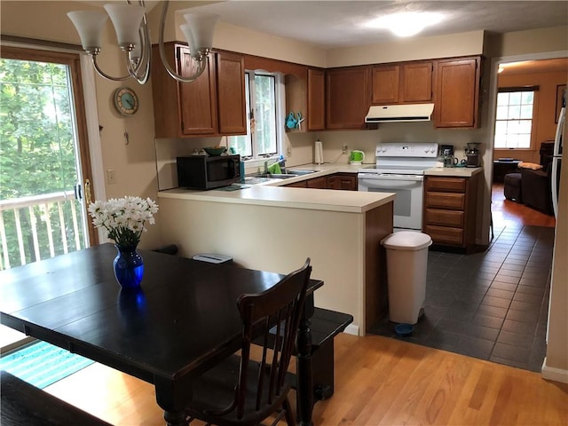 2 Marywood Ln, Cumberland, RI 02864 - kitchen featuring electric range, ventilation hood, light countertops, a peninsula, and brown cabinets