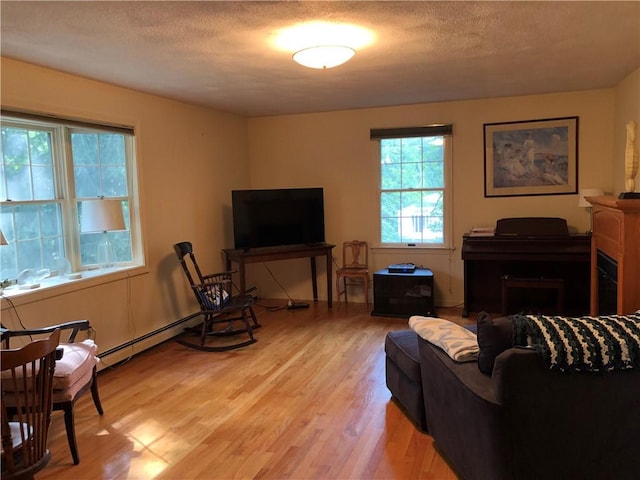 2 Marywood Ln, Cumberland, RI 02864 - living room with light wood-style floors, a textured ceiling, and baseboard heating