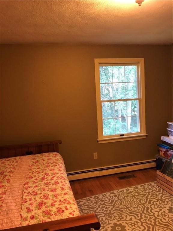 2 Marywood Ln, Cumberland, RI 02864 - bedroom with wood finished floors and a baseboard radiator