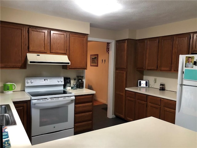 2 Marywood Ln, Cumberland, RI 02864 - kitchen with under cabinet range hood, white appliances, and light countertops
