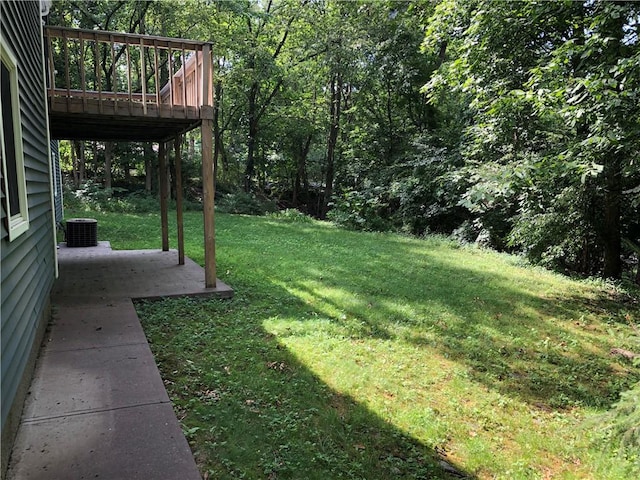 2 Marywood Ln, Cumberland, RI 02864 - view of green lawn with a deck, a forest view, and a patio area