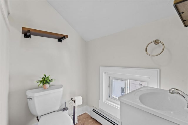 57 Maple Ave, Johnston, RI 02919 - half bathroom featuring a baseboard heating unit, lofted ceiling, wood finished floors, and vanity