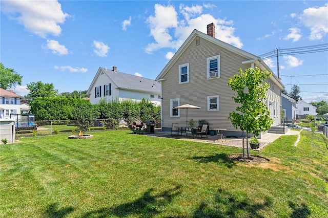 57 Maple Ave, Johnston, RI 02919 - back of house featuring a chimney and a patio