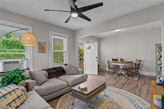 57 Maple Ave, Johnston, RI 02919 - living area featuring ceiling fan, wood finished floors, cooling unit, and a textured ceiling