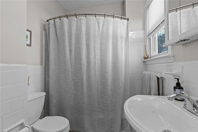 57 Maple Ave, Johnston, RI 02919 - bathroom with tile walls, a wainscoted wall, a shower with shower curtain, and a textured ceiling