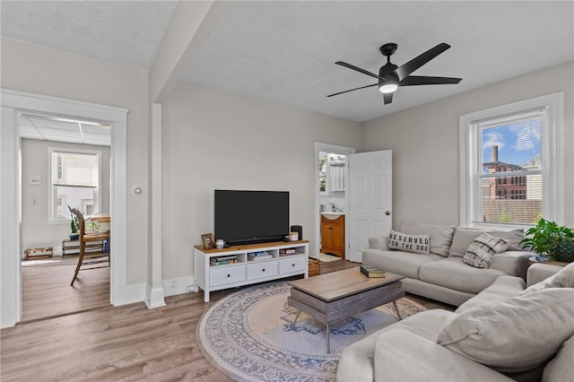 57 Maple Ave, Johnston, RI 02919 - living room featuring light wood-type flooring, a ceiling fan, and plenty of natural light