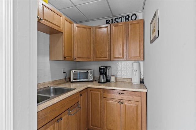 57 Maple Ave, Johnston, RI 02919 - kitchen with light countertops, tasteful backsplash, a paneled ceiling, and brown cabinetry