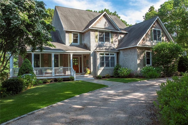 27 Tom Harvey Rd, Westerly, RI 02891 - shingle-style home with covered porch, a front yard, driveway, and a shingled roof