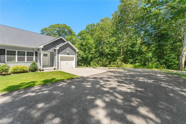 1 Lily Ln Unit 1, West Warwick, RI 02893 - view of front facade featuring a garage, driveway, roof with shingles, and a front yard