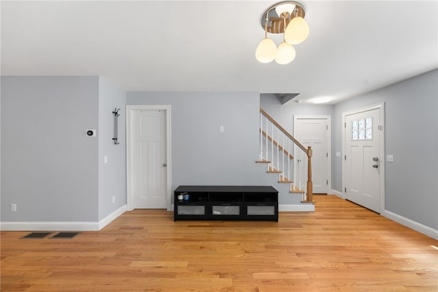 1 Lily Ln Unit 1, West Warwick, RI 02893 - foyer with stairs, light wood-style flooring, and a chandelier