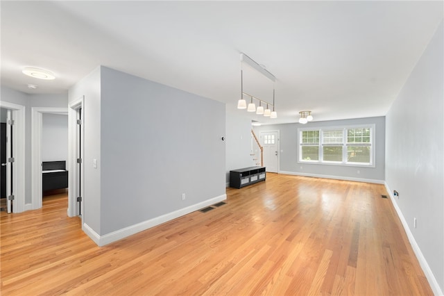 1 Lily Ln Unit 1, West Warwick, RI 02893 - unfurnished living room featuring stairs and light wood finished floors