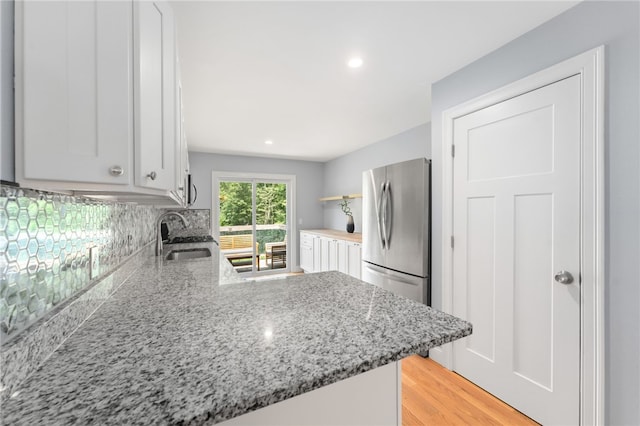 1 Lily Ln Unit 1, West Warwick, RI 02893 - kitchen with freestanding refrigerator, white cabinetry, open shelves, decorative backsplash, and recessed lighting