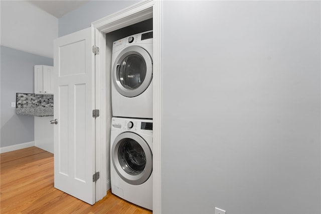1 Lily Ln Unit 1, West Warwick, RI 02893 - laundry area with stacked washer and clothes dryer and light wood-style flooring
