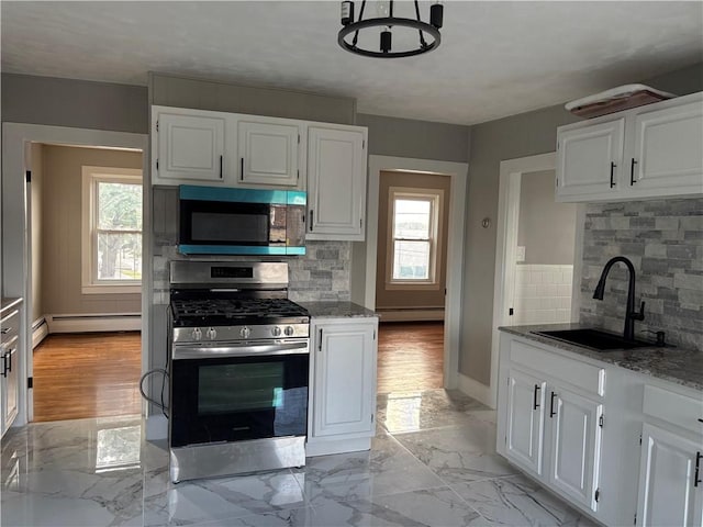 784 York Ave, Pawtucket, RI 02861 - kitchen featuring appliances with stainless steel finishes, a baseboard heating unit, white cabinets, decorative backsplash, and light stone counters