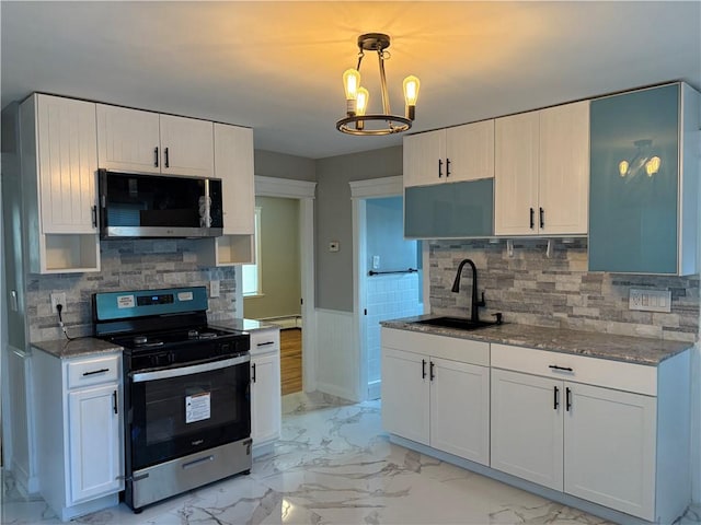 784 York Ave, Pawtucket, RI 02861 - kitchen featuring appliances with stainless steel finishes, light marble finish floors, wainscoting, light stone countertops, and baseboard heating