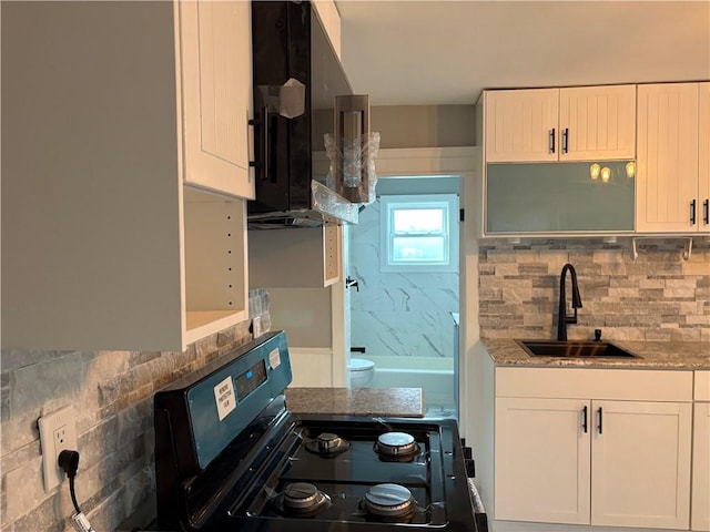 784 York Ave, Pawtucket, RI 02861 - kitchen featuring range with gas cooktop, decorative backsplash, light stone counters, and white cabinets