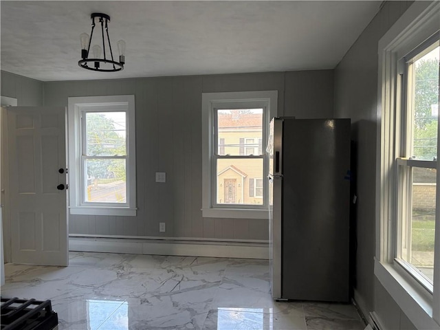784 York Ave, Pawtucket, RI 02861 - unfurnished dining area featuring healthy amount of natural light, light marble finish floors, and a baseboard heating unit