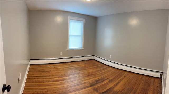 784 York Ave, Pawtucket, RI 02861 - empty room with wood finished floors and a baseboard heating unit