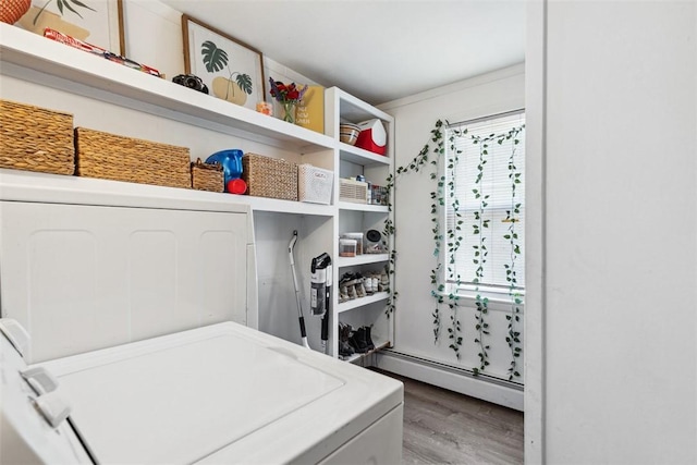 67 Pleasant St, Westerly, RI 02891 - laundry area with baseboard heating, washer and dryer, and wood finished floors