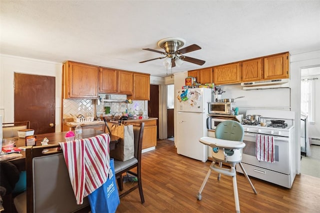 67 Pleasant St, Westerly, RI 02891 - kitchen featuring white appliances, under cabinet range hood, brown cabinets, dark wood-type flooring, and a ceiling fan