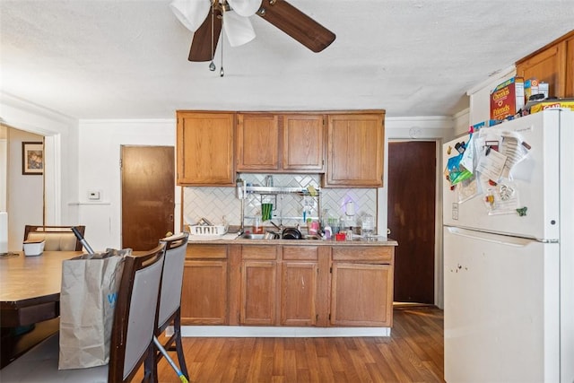 67 Pleasant St, Westerly, RI 02891 - kitchen featuring freestanding refrigerator, tasteful backsplash, ceiling fan, and brown cabinets