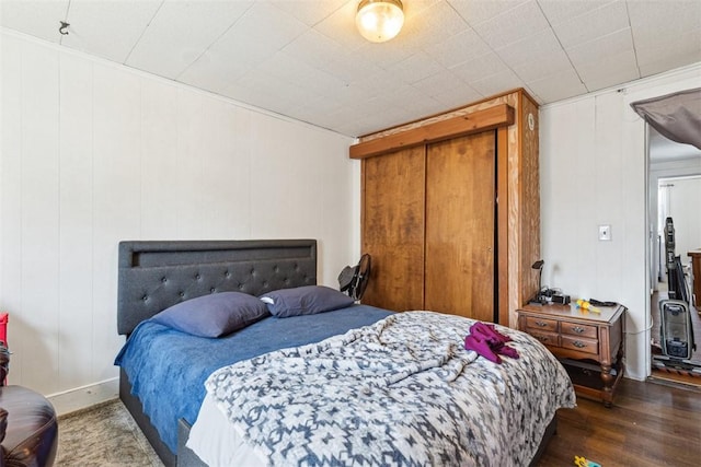 67 Pleasant St, Westerly, RI 02891 - bedroom with dark wood finished floors, a closet, and a decorative wall
