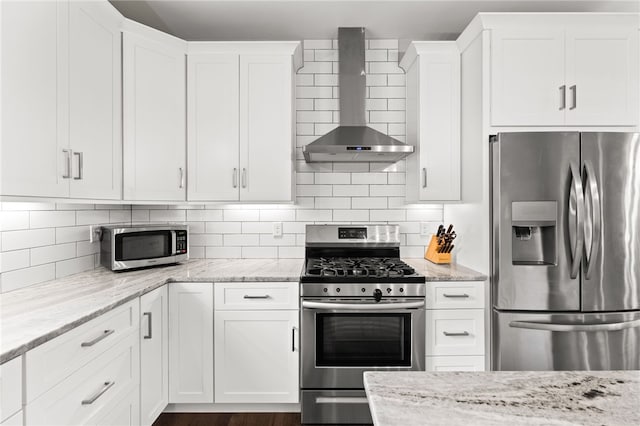 15 Mathew Rd, Tiverton, RI 02878 - kitchen with stainless steel appliances, wall chimney range hood, white cabinets, light stone countertops, and tasteful backsplash