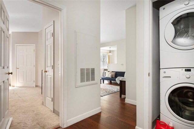 112 Mill St Unit 203, Woonsocket, RI 02895 - laundry room featuring stacked washer / dryer and wood finished floors