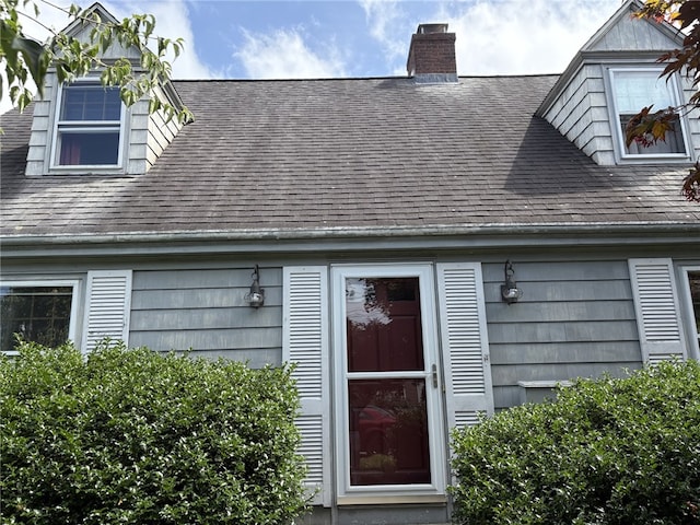 10 Jesse Davis Ln, Barrington, RI 02806 - doorway to property with a shingled roof and a chimney
