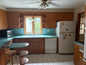 10 Jesse Davis Ln, Barrington, RI 02806 - kitchen featuring white appliances, brown cabinets, ceiling fan, and light countertops