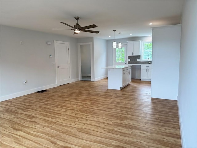 5 Crawford St, West Warwick, RI 02893 - kitchen featuring open floor plan, white cabinetry, light wood finished floors, and recessed lighting