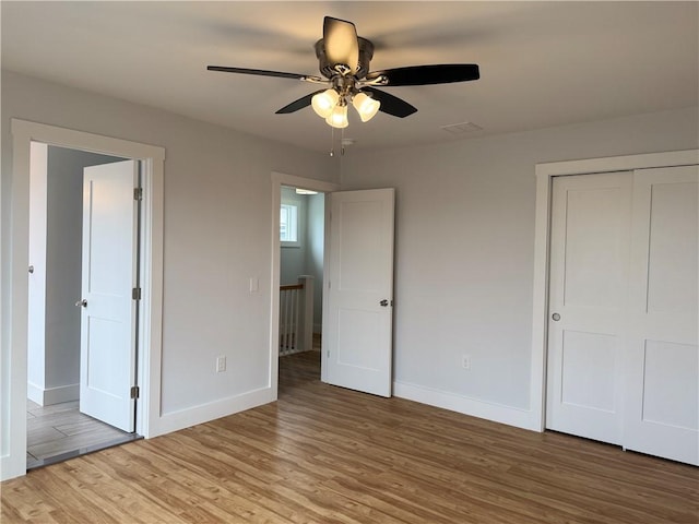 5 Crawford St, West Warwick, RI 02893 - unfurnished bedroom featuring light wood-type flooring, a closet, and a ceiling fan