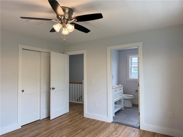 5 Crawford St, West Warwick, RI 02893 - unfurnished bedroom featuring wood finished floors, a closet, ensuite bathroom, and a ceiling fan