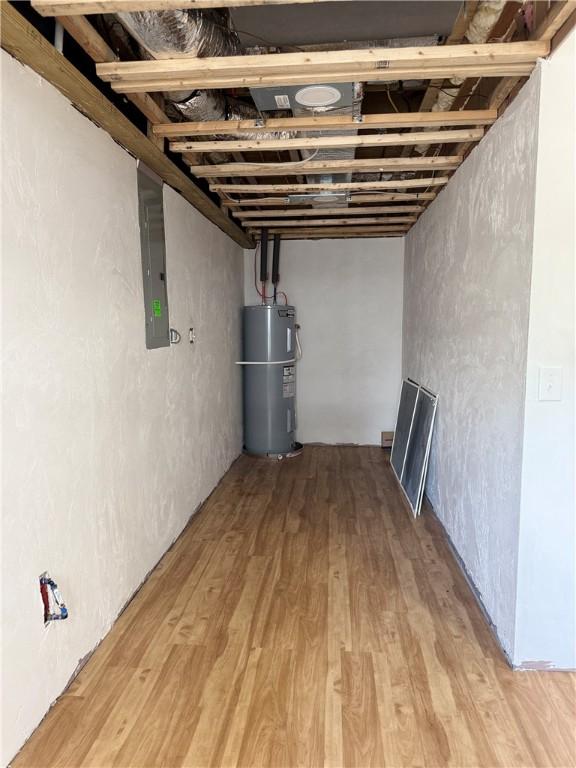 5 Crawford St, West Warwick, RI 02893 - finished basement featuring water heater, electric panel, and light wood finished floors