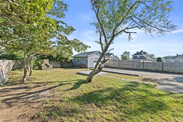 3 Riverview Ave, Westerly, RI 02891 - fenced backyard featuring exterior fireplace and an outbuilding