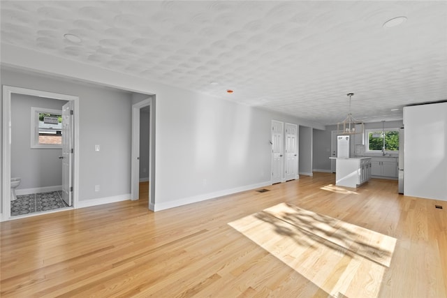 3 Riverview Ave, Westerly, RI 02891 - unfurnished living room with baseboards and light wood finished floors