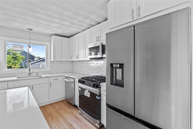 3 Riverview Ave, Westerly, RI 02891 - kitchen featuring appliances with stainless steel finishes, light countertops, white cabinetry, and light wood-style floors