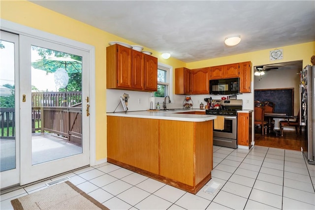 65 Jeri Lynn Cir, Warwick, RI 02886 - kitchen featuring stainless steel appliances, a peninsula, light countertops, and brown cabinets
