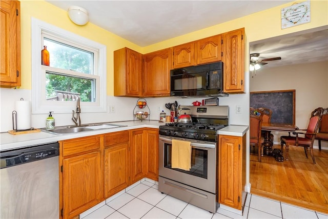 65 Jeri Lynn Cir, Warwick, RI 02886 - kitchen with appliances with stainless steel finishes, light countertops, brown cabinetry, and a ceiling fan