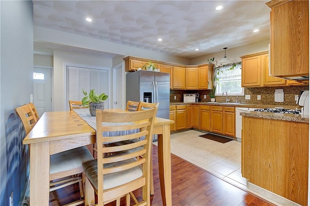 73 Fessenden St, Warwick, RI 02886 - kitchen featuring decorative backsplash, stainless steel fridge with ice dispenser, hanging light fixtures, recessed lighting, and light wood-type flooring