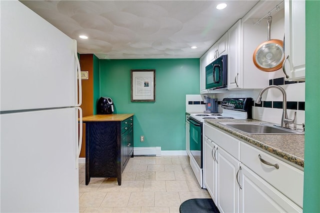 73 Fessenden St, Warwick, RI 02886 - kitchen with white appliances, white cabinetry, recessed lighting, baseboard heating, and light tile patterned floors