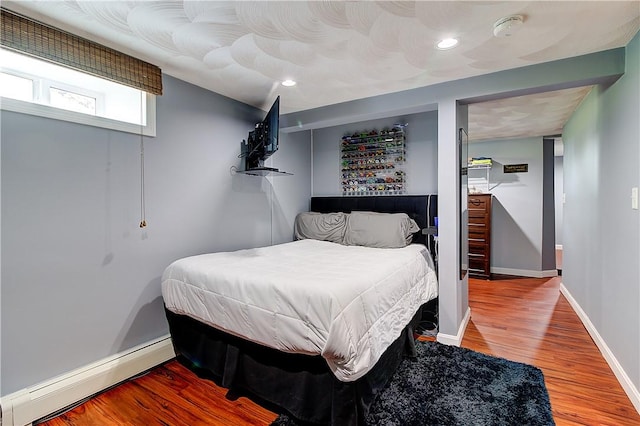 73 Fessenden St, Warwick, RI 02886 - bedroom with a baseboard radiator, wood finished floors, and recessed lighting