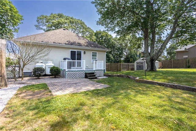 73 Fessenden St, Warwick, RI 02886 - back of house with a patio, a shed, a fenced backyard, a wooden deck, and roof with shingles