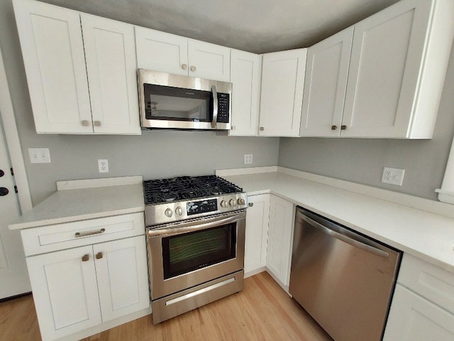 16 Fyffe Ave, Cranston, RI 02920 - kitchen with appliances with stainless steel finishes, light wood finished floors, white cabinets, and light countertops