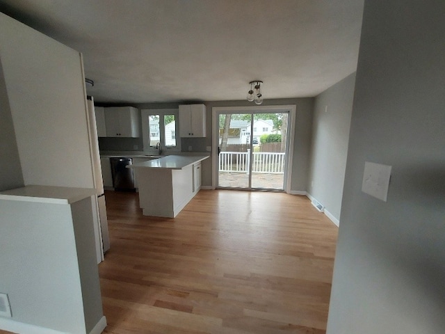 16 Fyffe Ave, Cranston, RI 02920 - kitchen featuring light wood-type flooring, dishwasher, white cabinetry, and light countertops