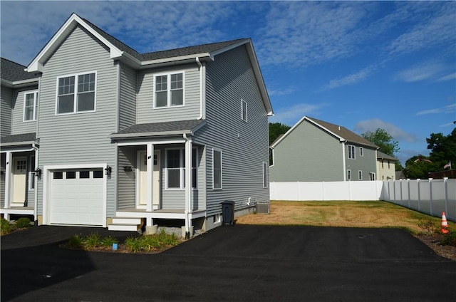 68 Greene St Unit 5, Warwick, RI 02886 - view of front of house featuring driveway, a garage, and a shingled roof