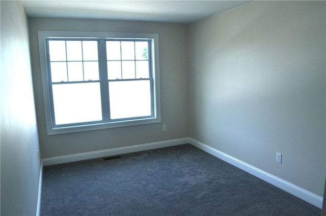 68 Greene St Unit 5, Warwick, RI 02886 - spare room with healthy amount of natural light and dark colored carpet